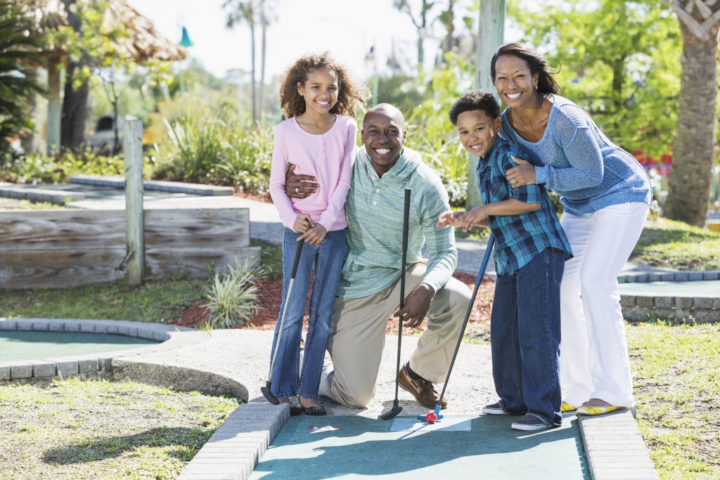 Family Playing Mini Golf